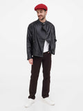 Side profile man in burgundy linen newsboy cap showing straight visor detail black leather jacket