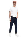 Man wearing cappuccino cotton flat cap with white t-shirt and dark jeans full body front view