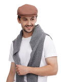 Smiling man wearing cappuccino baker boy hat with grey vest close-up portrait shot