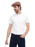 Close-up of man in cappuccino baker boy hat casual pose with hands in pockets