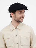 Close-up front view black cashmere newsboy cap showing 8 panel slouchy construction