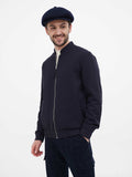 Close-up front navy blue newsboy cap on man showing 8 panel slouchy construction