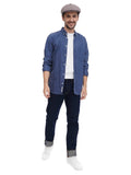 Man wearing earthy cocoa 8-panel baker boy hat with denim shirt smiling front view
