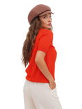 Side profile of woman wearing cocoa brown cotton baker boy cap with long dark hair