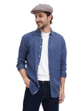 Man in cocoa 8-panel newsboy cap casual pose with hands in pockets denim outfit