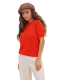 Woman in red top and cream trousers wearing cocoa brown cotton newsboy cap portrait