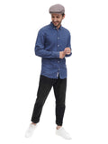 Full body shot man in cocoa flat cap with blue denim shirt and black pants