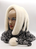 Detail view cream mink fur hat hood cowl showing black patterned knit fabric texture and mink pompon accent