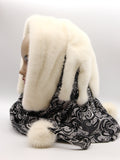 Three-quarter back view cream mink fur hat hood cowl showing mink crown and black patterned knit cowl body