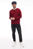 Man wearing dark blue wool flat cap with burgundy sweater full body front view