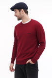 Close-up of man in dark blue baker boy hat with burgundy sweater side angle view
