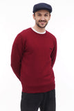Dark blue newsboy cap styled with burgundy sweater casual standing pose
