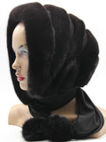 Dark brown mink and black suede striped fur hat hood with black fabric ties and pompons on mannequin, front view