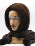 Side profile dark chocolate mink fur hat hood with brown scarf on mannequin showing mink pompon at scarf end