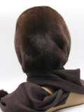 Three-quarter back view dark chocolate mink fur hat hood with brown fabric scarf and mink pompon visible