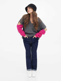 Full-length view of dark grey cloche hat with grey sweater and jeans