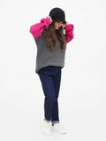 Woman in dark grey cloche hat and grey sweater outfit, standing full-length