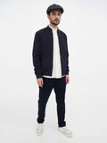 Man in dark grey herringbone newsboy cap full body casual outfit