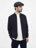 Man wearing dark grey herringbone cap full body side angle
