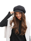 Close-up portrait of woman wearing dark grey raw cashmere newsboy cap
