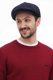 Torso front view man in dark navy tweed newsboy cap with burgundy sweater casual smile