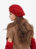 French style red beret with flower for women, three-quarter view showing hat position on head