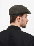 Front close-up green slouchy newsboy cap paired with black bomber jacket