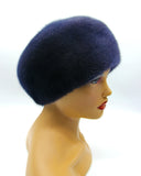 Graphite blue mink gathered beret three-quarter left view showing dark blue fur tone and tuck ridge pattern
