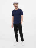 Man in gray linen newsboy cap full body black pants