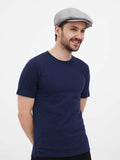 Man in gray linen newsboy cap full body navy outfit