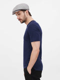 Man wearing gray linen newsboy cap side view navy shirt
