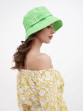 Close-up of decorative belt with stone accent on green bucket hat