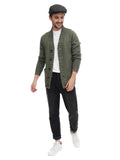 Full body shot man in green tweed flat cap with olive jacket black pants white sneakers