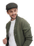Side profile man wearing green tweed flat cap with olive jacket casual smile