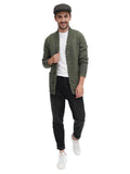 Three quarter view man in green tweed plaid flat cap with olive jacket casual stance