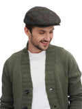 Torso front angle man wearing green tweed flat cap with olive cardigan white shirt