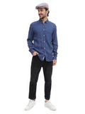 Man in grey flat cap torso view front angle with blue denim shirt