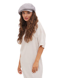 Front portrait of woman wearing grey 8-panel cotton newsboy cap
