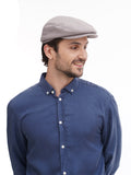 Full body shot man in grey flat cap with blue denim shirt and black pants