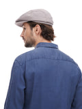 Side angle man wearing grey flat cap with blue denim shirt casual smile