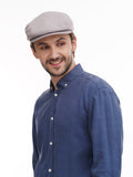 Back profile view man in grey flat cap with denim shirt showing construction
