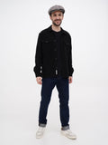 Man wearing grey herringbone 8-panel newsboy cap standing front view with black shirt