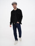 Three quarter view man in grey herringbone baker boy hat with black shirt casual pose