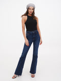 Grey linen beret for women full length front view with black sleeveless top and dark flared jeans