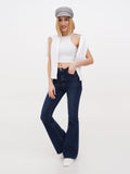 Woman walking in grey linen Breton cap, white top and navy flared jeans