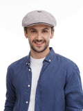 Man in grey cotton flat cap torso view front angle with denim shirt casual smile