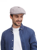 Man wearing grey 8-panel flat cap upper body close-up view with denim shirt detail