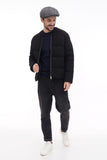 Full body shot man wearing grey tweed 8-panel newsboy cap with all black outfit