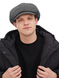 Man wearing grey tweed newsboy cap front view black winter jacket