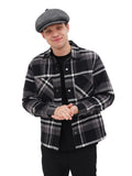 Man adjusting grey wool newsboy cap full length winter outfit